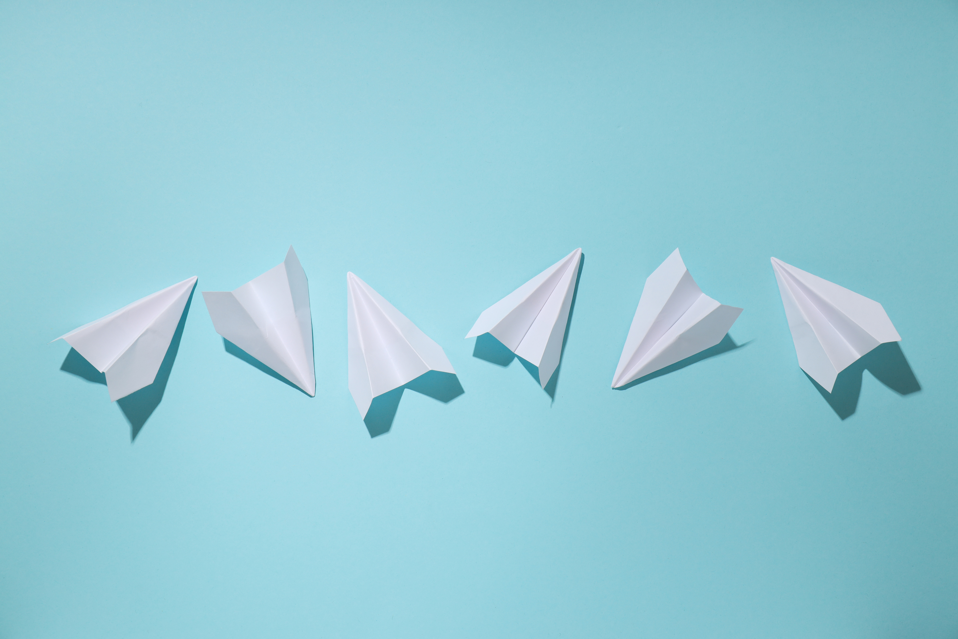 Business, startup and sponsorship concept with paper planes on b